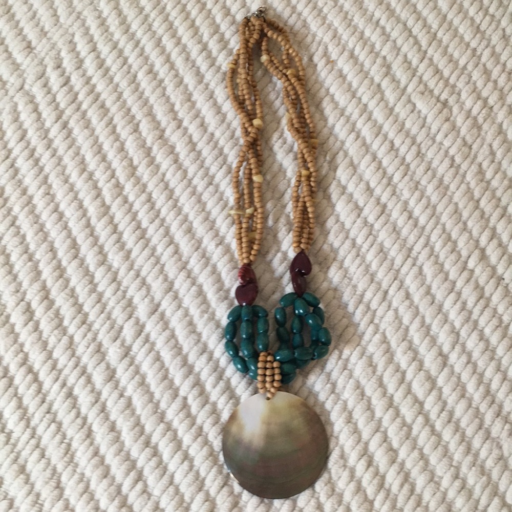 Neutral and dark turquise toned statement necklace.